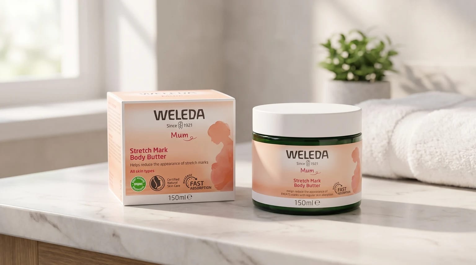 A box and jar of Weleda Mum Stretch Mark Body Butter sitting on a marble countertop in a bright bathroom.