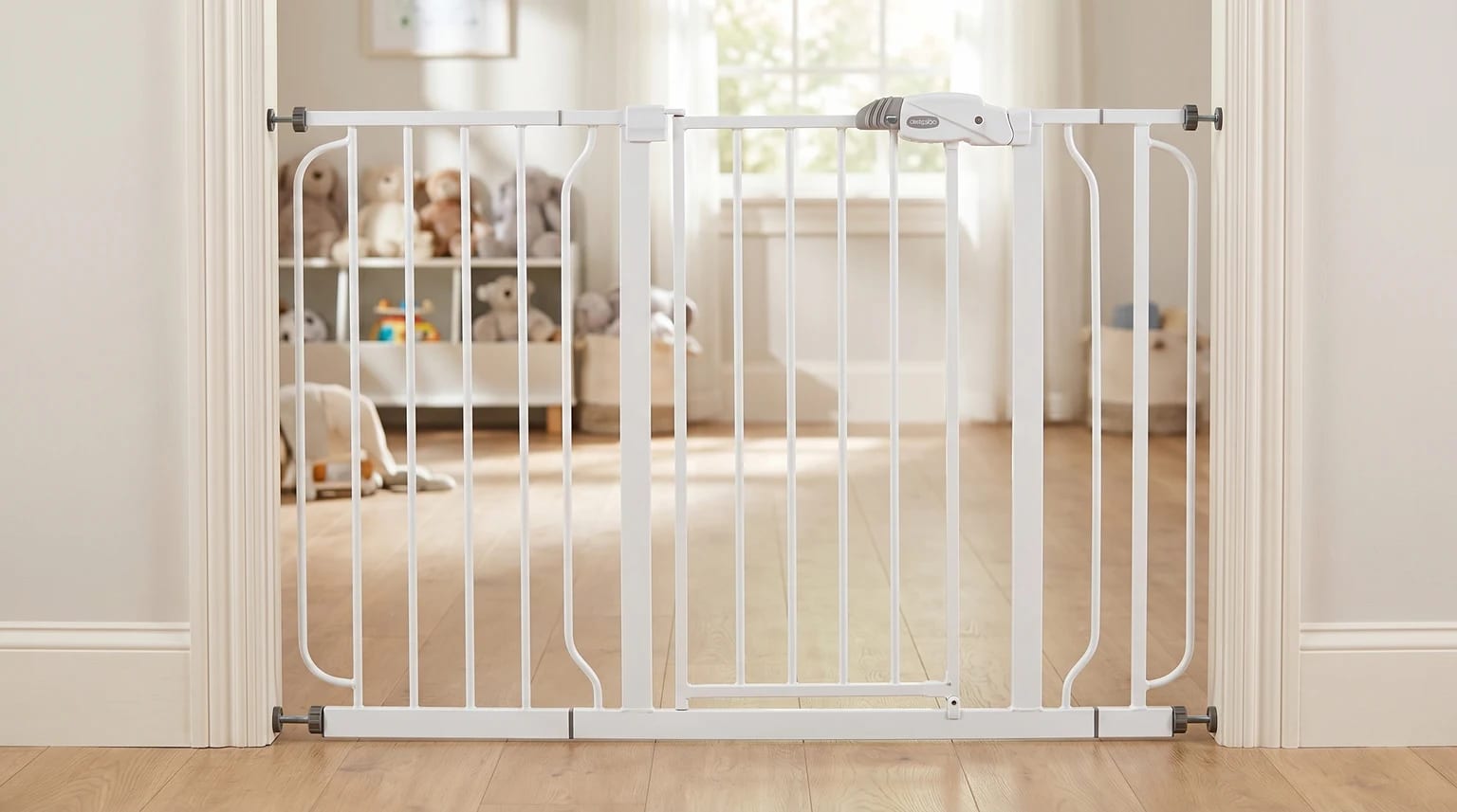 A white Regalo pressure-fit baby gate installed in a normal doorway, with a bright playroom visible beyond it.